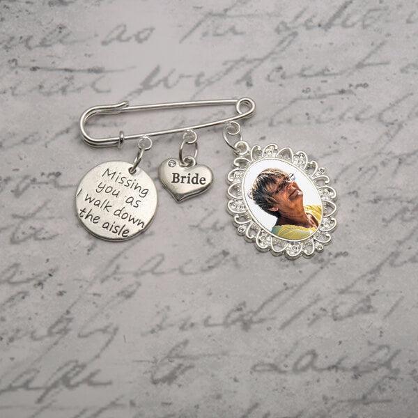 wedding brooch with charms and a photo